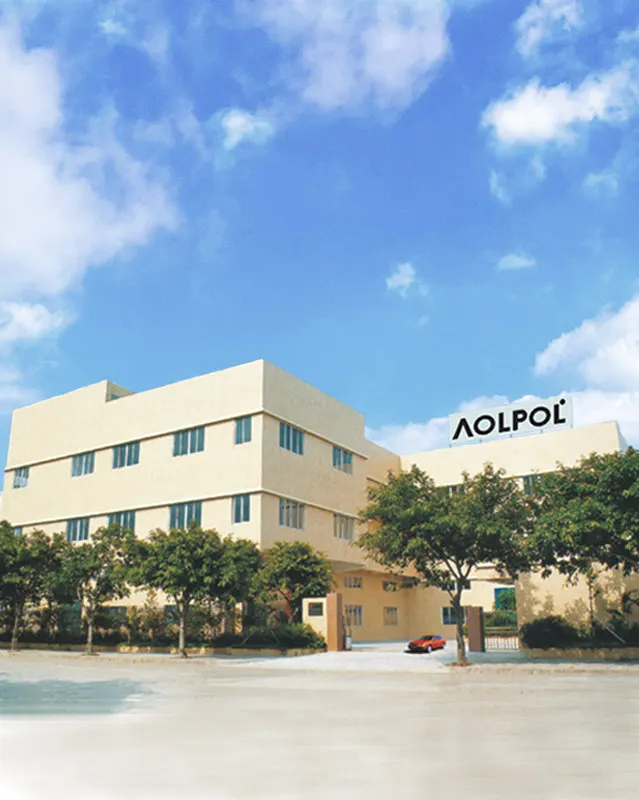 The image shows the exterior of the AOLPOL Lighting factory a large modern building with a beige facade and multiple windows