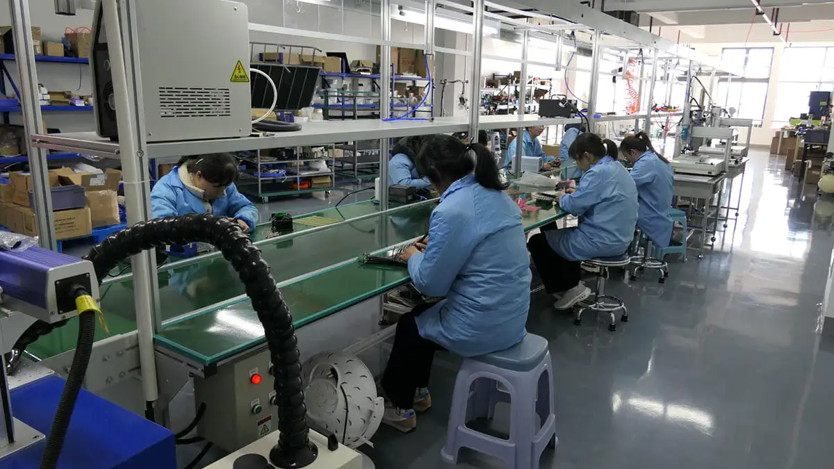 Workers operating machines inside NOVA factory